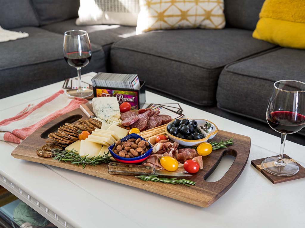 Each board is unique in shape and features two live edges and a handle cut into each end of a single piece of beautiful Black Walnut wood. Can be used as both a cutting board and charcuterie board. Boards are hand sanded.